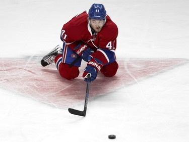 Paul Byron  of the Montreal Canadiens makes a pass from his knees against the Buffalo Sabres in the first period of an NHL game at the Bell Centre in Montreal Thursday, March 10, 2016.