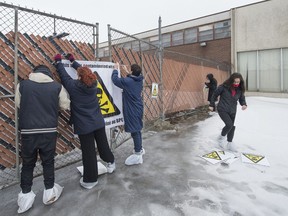 Members the Quebec Green Party put up danger tape and banners at the entrance of the former Reliance Power Equipment property on Hymus Blvd. in Pointe-Claire on Friday, March 11, 2016.