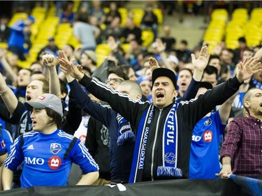 Montreal Impact fans cheer before the start of the Impact's home opening match against the New York Red Bulls at the Olympic Stadium in Montreal on Saturday, March 12, 2016.