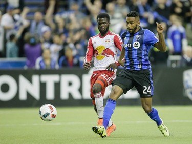 Montreal Impact forward Anthony Jackson-Hame, right, shoots to score a goal as he is chased by New York Red Bulls defender Kemar Lawrence, left, during the second half of the Impact's home opening match at the Olympic Stadium in Montreal on Saturday, March 12, 2016.