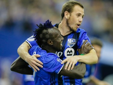 Montreal Impact forward Dominic Oduro, left, celebrates with teammate Harrison Shipp, right,  after scoring against the New York Red Bulls during the second half of the Impact's home opening match at the Olympic Stadium in Montreal on Saturday, March 12, 2016.