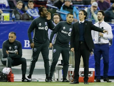 Montreal Impact head coach Mauro Biello, second from right, gestures during the second half of the Impact's home opening match against the New York Red Bulls at the Olympic Stadium in Montreal on Saturday, March 12, 2016.