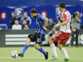 Impact's Ignacio Piatti finds mark with his shot as New York Red Bulls' Karl Ouimette defends during the second half of the Impact's home opener at the Olympic Stadium in Montreal on March 12, 2016.