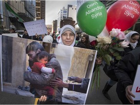 Hundreds of marchers marked the fifth anniversary of the Syrian conflict on Sunday. Dozens of similar events were held in cities across the world.