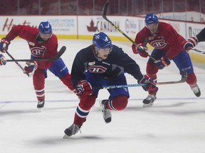 Defenceman Nathan Beaulieu takes part in the Montreal Canadiens practice in Montreal Monday, March 14, 2016 Tuesday night at the Bell Centre. Pursuing him are teammates Lucal Lessio (left) and Michael McCarron.