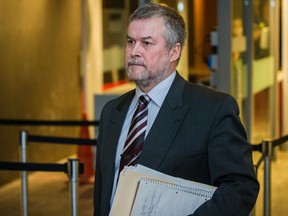 Former Sûreté du Québec assistant director Jean Audette leaves the courtroom during a break in an SQ fraud trial at the Montreal courthouse on Monday, March 14, 2016.