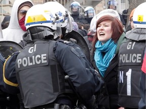 A woman yells at police officers on de Chateaubriand Ave. at the annual anti-police brutality march which took place near the Jean-Talon métro in Montreal, on Saturday, March 15, 2014.