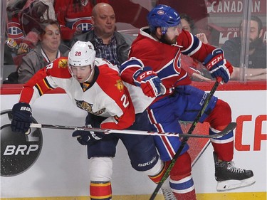 MONTREAL, QUE.: MARCH  15, 2016 -- Montreal Canadiens' Greg Pateryn, right, and Florida Panthers' Garrett Wilson collide near the boards, during third period NHL action in Montreal on Tuesday March 15, 2016. (Pierre Obendrauf / MONTREAL GAZETTE)