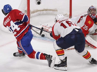 MONTREAL, QUE.: MARCH  15, 2016 -- Montreal Canadiens' Phillip Danault (24) fires puck at Florida Panthers goalie Al Montoya with Aleksander Barkov closing in on play, during first period NHL action in Montreal on Tuesday March 15, 2016. (Pierre Obendrauf / MONTREAL GAZETTE)