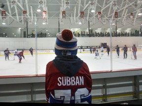 A youngster watches the Montreal Canadiens at practice at the Bell Sports Complex in Brossard near Montreal Friday, March 18, 2016. The team was preparing to face the Senators Saturday night in Ottawa.