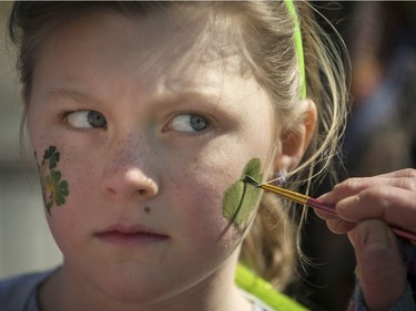 Madeline Brouillette keeps a wary eye on her painter as she prepares for the St. Patrick's Parade in Hudson on Saturday, March 19, 2016.