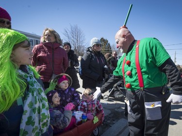 A clown entertains children during the St. Patrick's Parade in Hudson on Saturday, March 19, 2016.