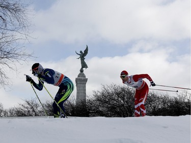 Skiers pass the George-Etienne Cartier Monument during the FIS World Cup race in Montreal on Wednesday March 2, 2016.