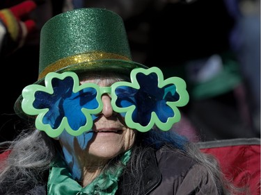 Sheila Provost watches the annual St. Patrick's Parade in Montreal on Sunday, March 20, 2016.
