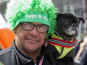 A dog and his best friend take in Montreal's St. Patrick's parade in 2015.