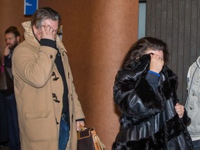 Arthur Trzciakowski, left, and wife Anita Obodzinski, right, cover their faces as they leave a courtroom after the hearing in the case of Veronika Piela, a 92 year-old woman who was allegedly defrauded by the couple and social worker Alissa Kerner, in Montreal on Tuesday, March 22, 2016.