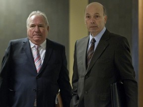 Former municipal political fundraiser  Bernard Trépanier, left, and former Montreal executive committee chairman Frank Zampino wait to enter a courtroom at the Montreal courthouse, Tuesday March 22, 2016, for the resumption of the Contrecoeur corruption trial.