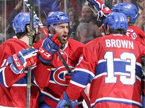 Montreal Canadiens Lucas Lessio, facing, celebrates his game winning goale against the Anaheim Ducks with team-mates Joel Hanley, left, Mike Brown and Jacob De La Rose during third period of National Hockey League game in Montreal Tuesday March 22, 2016.