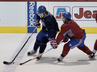 Canadiens defenceman Nathan Beaulieu, left, tries to hold back Canadiens centre David Desharnais during a team practice at the Bell Sports Complex in Montreal on Friday March 25, 2016.