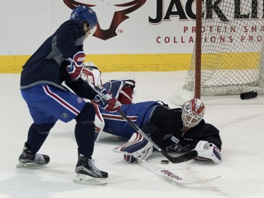 Canadiens defenceman Nathan Beaulieu is stopped by Montreal Canadiens goalie Ben Scrivens during a team practice at the Bell Sports Complex in Montreal on Friday March 25, 2016. (Allen McInnis / THE GAZETTE)