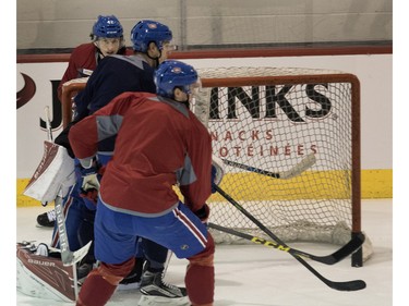 Canadiens' Sven Andrighetto, top left, eyes the play from behind the net during a team practice at the Bell Sports Complex in Montreal on Friday March 25, 2016.