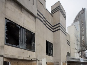 The lower windows of the Snowdon Theatre are boarded up, while the second level windows remain blown out,  in Montreal on Monday March 28, 2016. The theatre was hit by fire and police are investigating it as a possible arson case.