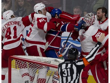 MONTREAL, QUE.: MARCH 29, 2016-- Detroit Red Wings goalie Jimmy Howard hits Montreal Canadiens right wing Mike Brown in the face with his blocker as Detroit Red Wings defenseman Danny DeKeyser tries to retrain Brown during NHL action at the Bell Centre in Montreal on Tuesday March 29, 2016. (Allen McInnis / MONTREAL GAZETTE)