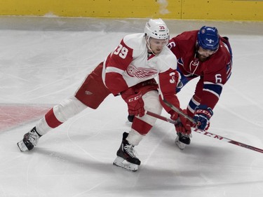 Detroit Red Wings right wing Anthony Mantha, right, is held back by Montreal Canadiens defenseman Greg Pateryn March 29, 2016.