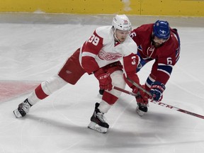 Detroit Red Wings right wing Anthony Mantha, right, is held back by Montreal Canadiens defenseman Greg Pateryn March 29, 2016.