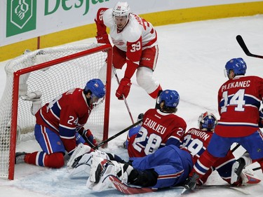 MONTREAL, QUE.: MARCH 29, 2016-- Detroit Red Wings right wing Anthony Mantha stuffs the puck past Montreal Canadiens left wing Phillip Danault to score the game tying goal during NHL action at the Bell Centre in Montreal on Tuesday March 29, 2016. Montreal Canadiens defenseman Nathan Beaulieu, and Montreal Canadiens center Tomas Plekanec had fallen on Montreal Canadiens goalie Mike Condon allowing the goal. (Allen McInnis / MONTREAL GAZETTE)