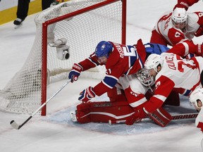 Montreal Canadiens center David Desharnais crashes on to Detroit Red Wings goalie Jimmy Howard after being hit from behind by Detroit Red Wings left wing Justin Abdelkader during NHL action at the Bell Centre in Montreal on Tuesday March 29, 2016. Detroit Red Wings defenseman Kyle Quincey also fell on to Mrazek during the play.