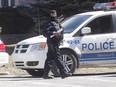 Montreal police officer on Gouin W, during an extensive police operation at a house on Laurin St. in Pierrefonds-Roxboro March 29, 2016.