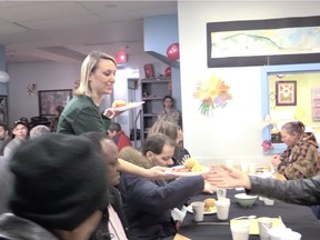 Volunteer Tamara Piniach serves sugar shack-themed food at St-Michael's Mission in Montreal.