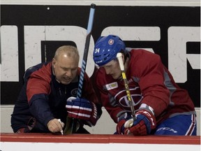 Canadiens head coach Michel Therrien draws a play on the boards for Canadiens rookie Michael McCarron during a team practice at the Bell Sports Complex in Montreal on Monday, March 7, 2016.