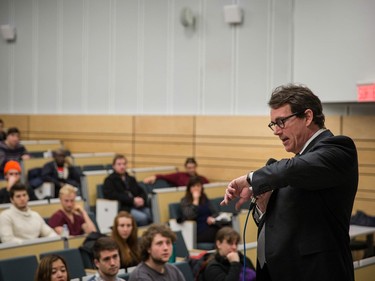 Parti Quebecois leader Pierre Karl Péladeau looks at his watch as he speaks to students during an event organized for sovereignty week at the Universite de Montreal in Montreal on Monday, March 7, 2016.