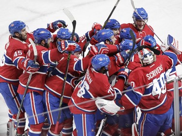 Alex Galchenyuk (far right #27) of the Montreal Canadiens is mobbed by teammates after his game-winning in the overtime period againt the Dallas Stars in an NHL game at the Bell Centre in Montreal Tuesday, March 8, 2016.