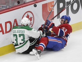 Canadiens' Lucas Lessio and Stars' Alex Goligoski collide in the third period Tuesday night at the Bell Centre. Montreal's prospects have received more ice time lately as a result of the team's spate of injuries.