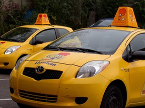 Delivery cars wait in the parking lot of a St-Hubert outlet on St-Denis St.