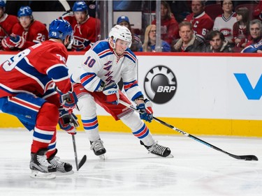 J.T. Miller #10 of the New York Rangers skates the puck against Andrei Markov #79 of the Montreal Canadiens during the NHL game at the Bell Centre on March 26, 2016, in Montreal.