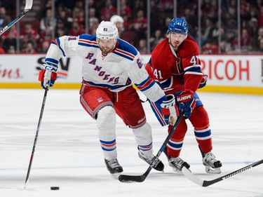 Rick Nash #61 of the New York Rangers skates the puck against Paul Byron #41 of the Montreal Canadiens during the NHL game at the Bell Centre on March 26, 2016, in Montreal.