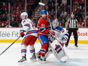 David Desharnais of the Montreal Canadiens battles for position with Jesper Fast of the New York Rangers and goaltender Antti Raanta during the NHL game at the Bell Centre on March 26, 2016, in Montreal.