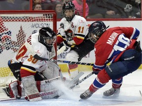 Calgary Inferno goalie Delayne Brian (30) puts the stop on Les Canadiennes de Montreal Noemie Marin (10) during first period of Canadian Women's Hockey League final action at the Clarkson Cup, Sunday March 13, 2016, in Ottawa.