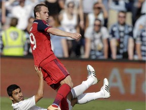 Sporting KC midfielder Paulo Nagamura, bottom, gives up the ball while covered by Chicago Fire midfielder Harry Shipp (19) during the second half of an MLS soccer match in Kansas City, Kan., on May 3, 2015. Shipp, Montreal's newest midfielder, is eager to put his emotional trade from Chicago behind him.