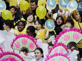 People walk in the International Women's Day march for gender equality and women's rights from the United Nations to Times Square, Sunday, March 8, 2015 in New York.