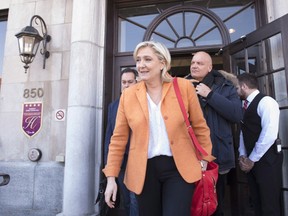 France's Front National Leader Marine Le Pen leaves a news conference, Sunday, March 20, 2016, in Quebec City.