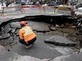 Workers in a sinkhole at the corner of Laval Ave. and Carré St-Louis in Montreal Thursday March 10, 2016.
