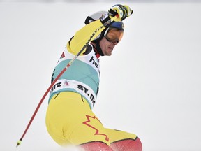 Canada's  Erik Guay reacts in the finish area after taking part in the Men's downhill at the FIS Alpine Skiing World Cup finals in St. Moritz on March 16, 2016.