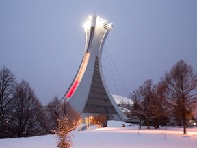 The Montreal Olympic Stadium lit in the colors of the Belgian flag, Wednesday March 23, 2016, in solidarity with the victims of the terror attacks in Brussels on Tuesday.