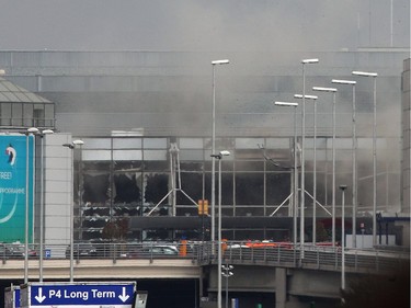 Smoke billows from the  Zaventem Airport after a controlled explosion in Brussels, Tuesday, March 22, 2016. Bombs struck the Brussels airport and one of the city's metro stations Tuesday, killing and wounding dozens of people, as a European capital was again locked down amid heightened security threats.