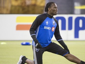 Montreal Impact's Didier Drogba stretches during a training session in Montreal, Tuesday, March 1, 2016.